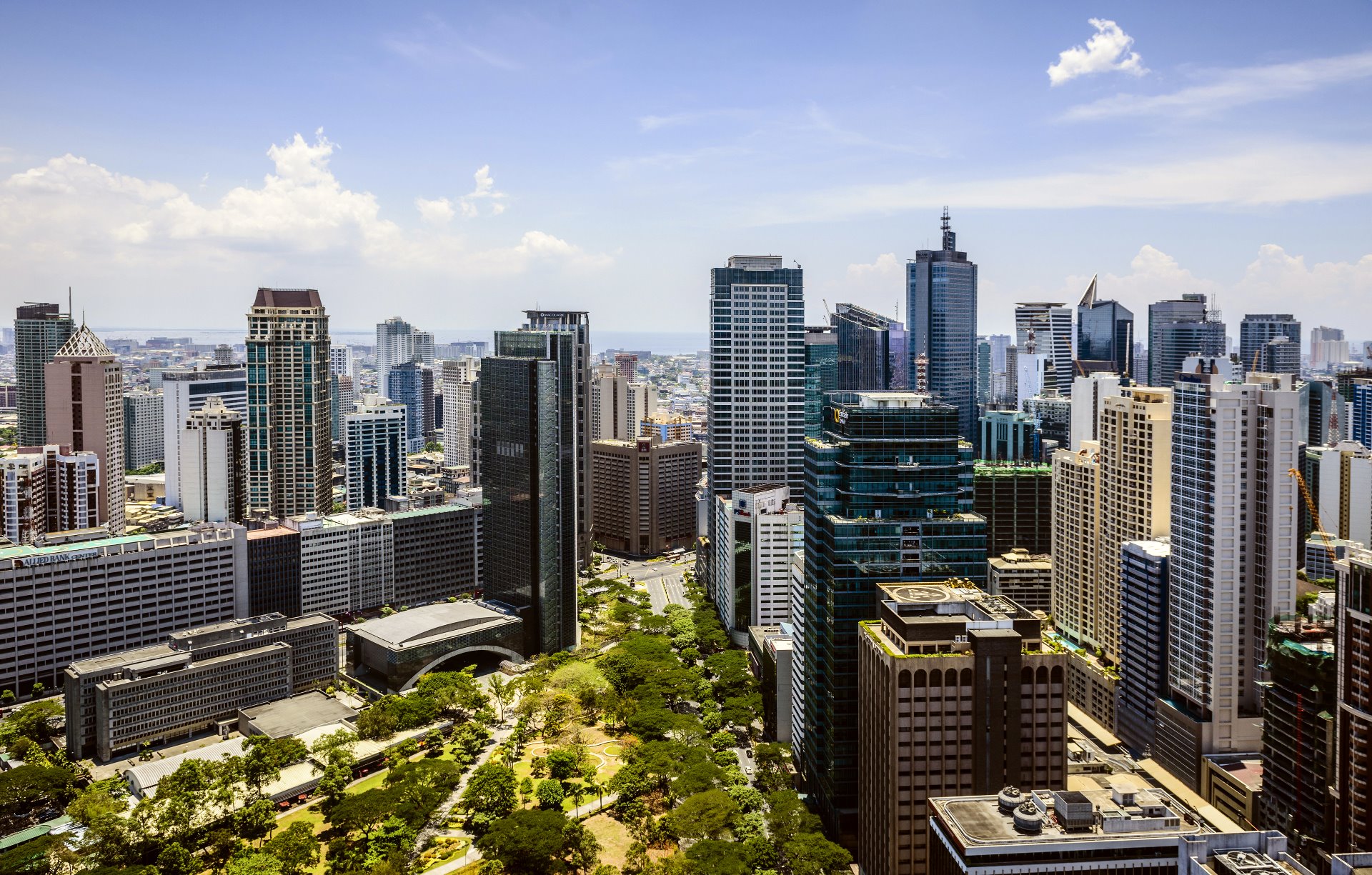 Manila (Philippines) cityscape under blue sky.